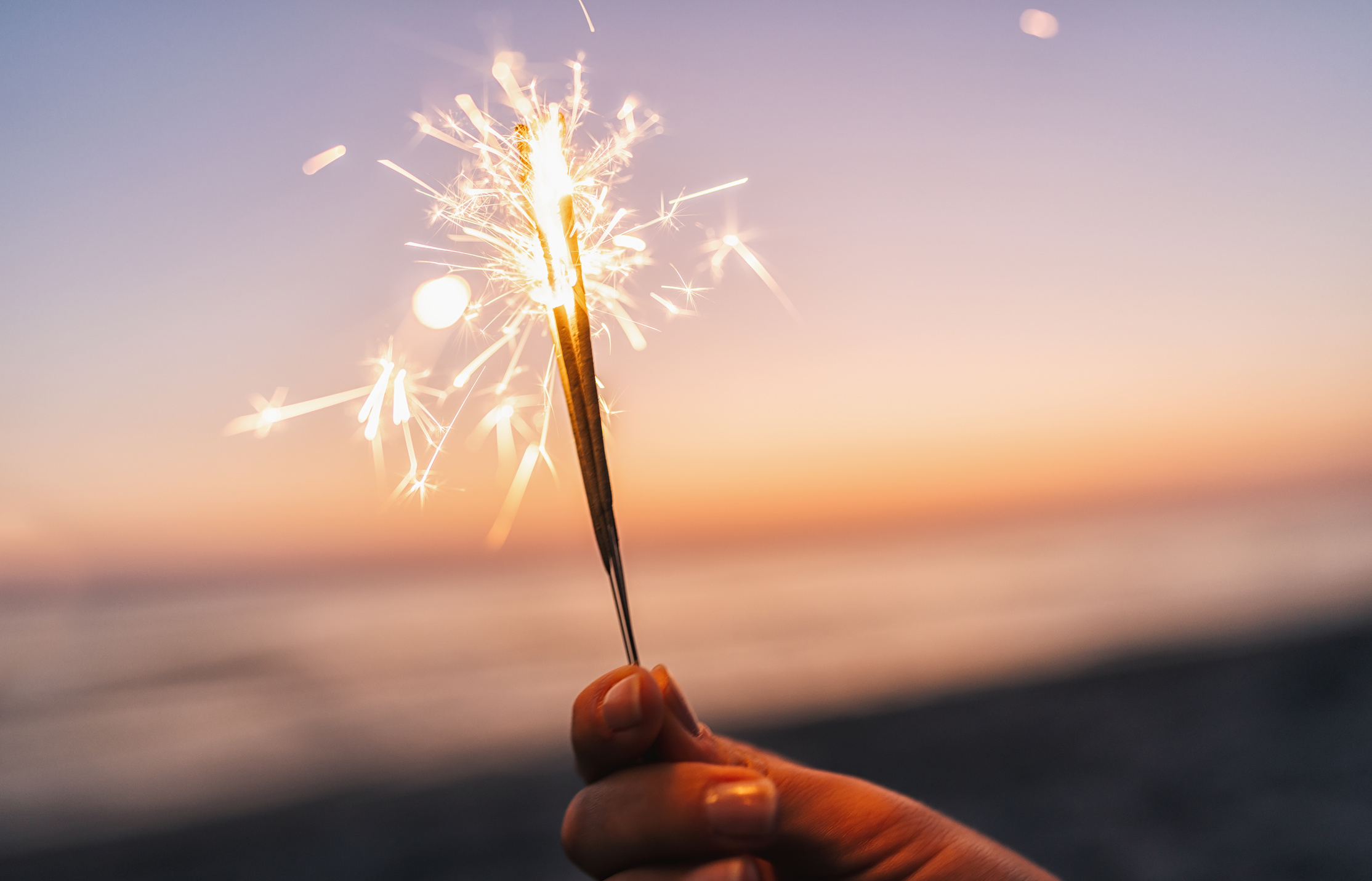 Holding Sparklers at Beach